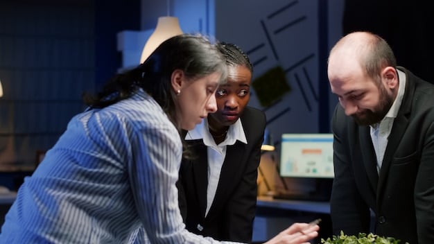 A diverse group of employees discussing payroll changes in a modern office setting. The focus is on collaboration and understanding the new regulations, with digital displays showing relevant data.